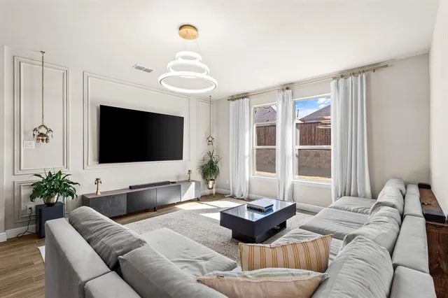 a living room with furniture and a flat screen tv