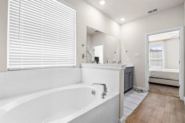 a bathroom with a tub and shower