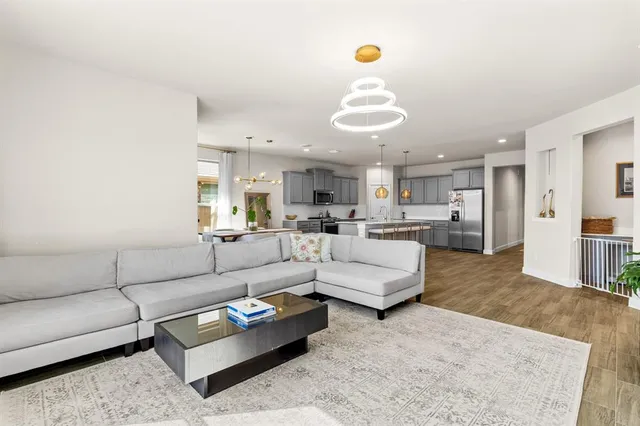 a living room with furniture kitchen and a table