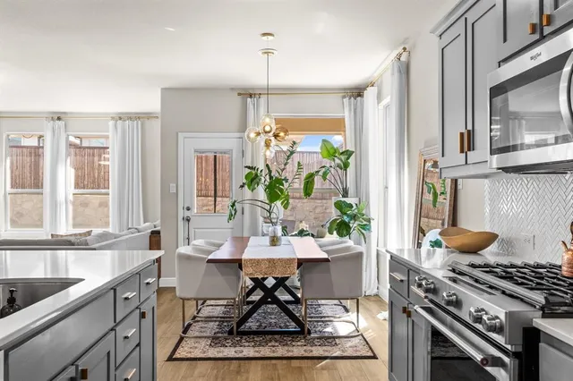 a kitchen with a stove a sink and a dining table