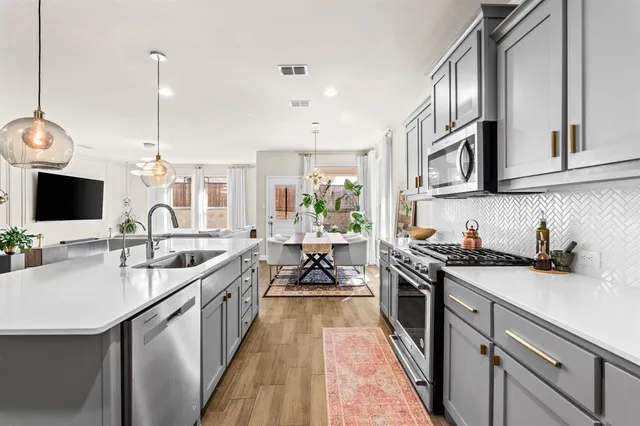 a kitchen with a sink stove and cabinets