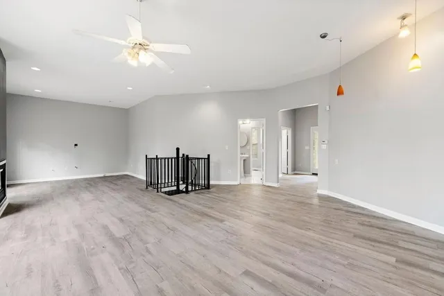 a view of an empty room with wooden floor