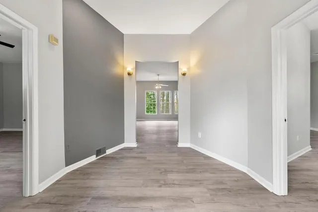 an empty room with windows and entrance