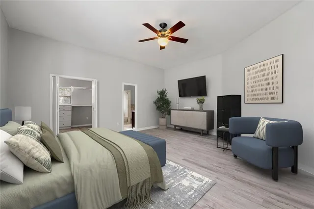 a bedroom with bed couch and window