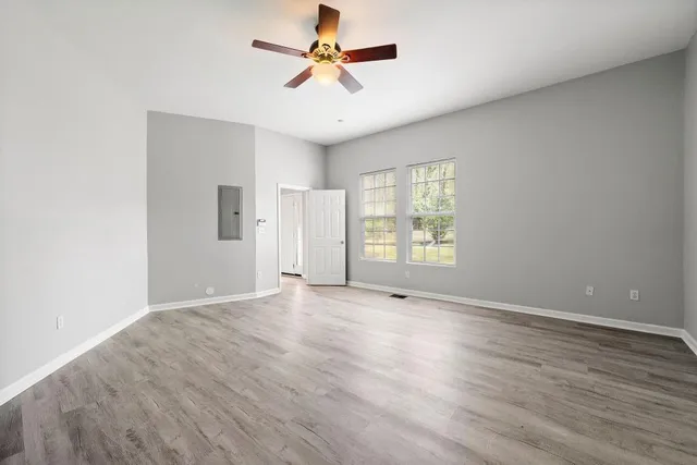 wooden floor in an empty room with a window