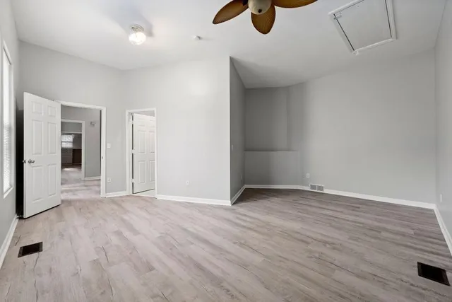 a view of an empty room with wooden floor