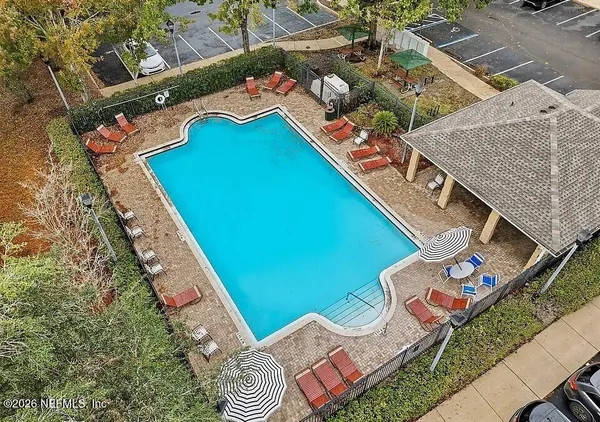 an aerial view of a house with a garden and lake view