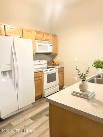 a kitchen with a sink a stove and refrigerator