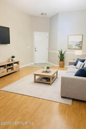 a living room with furniture and a flat screen tv