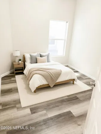 a bedroom with a bed and a large window