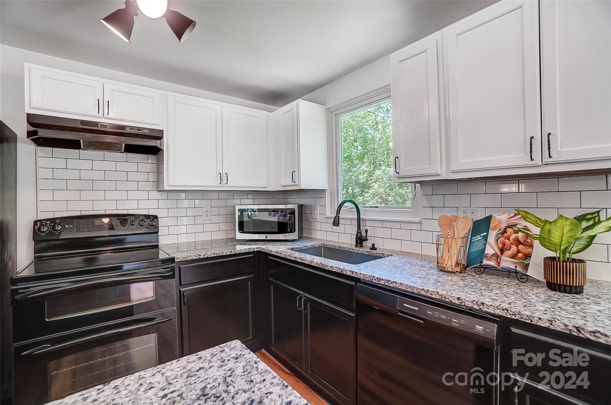 2236 Rice Planters Road Charlotte, NC 28273 - Photo 11 of 43 a kitchen with granite countertop a sink stainless steel appliances and cabinets