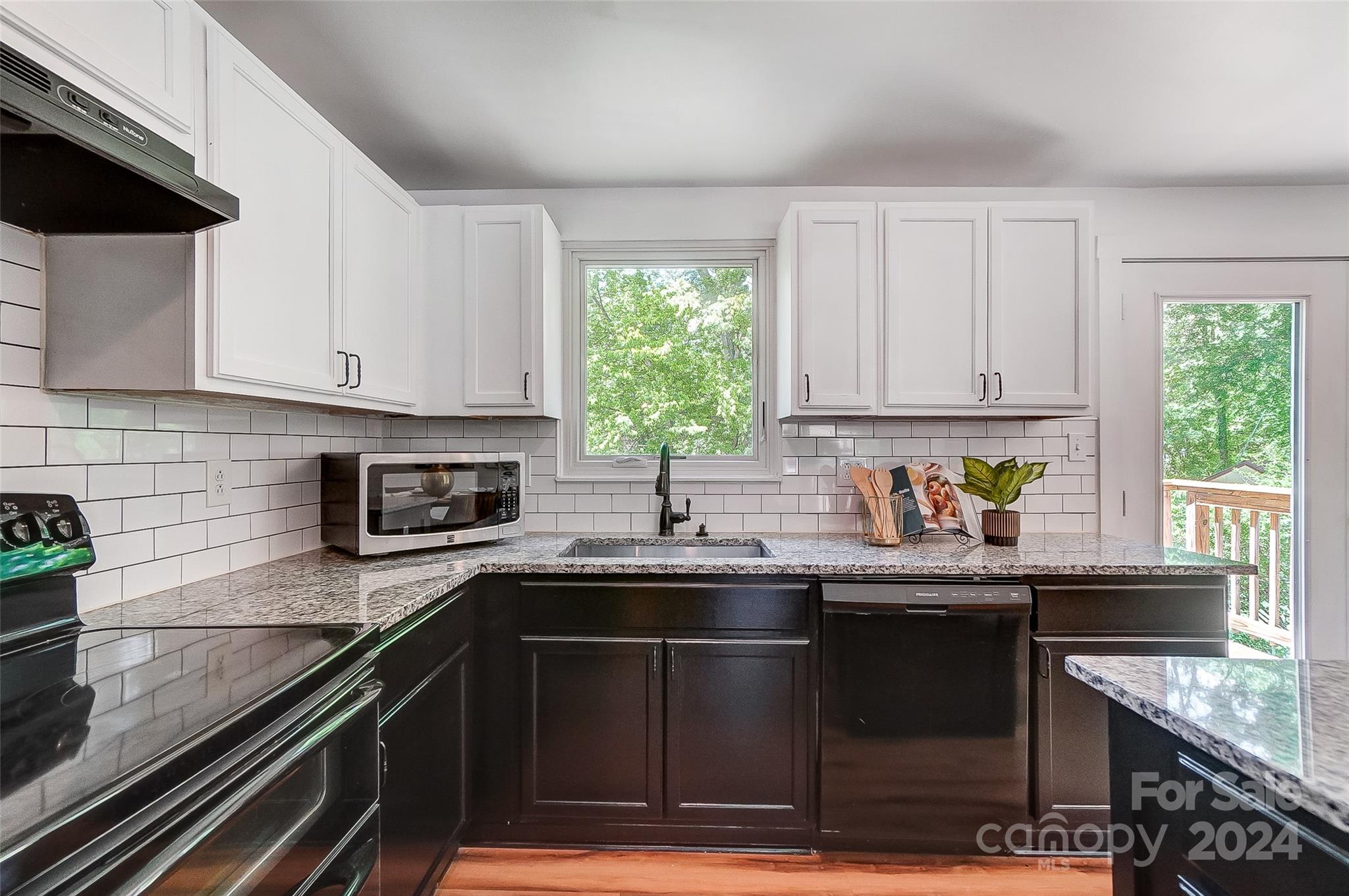 2236 Rice Planters Road Charlotte, NC 28273 - Photo 12 of 43 a kitchen with granite countertop a sink a stove and cabinets