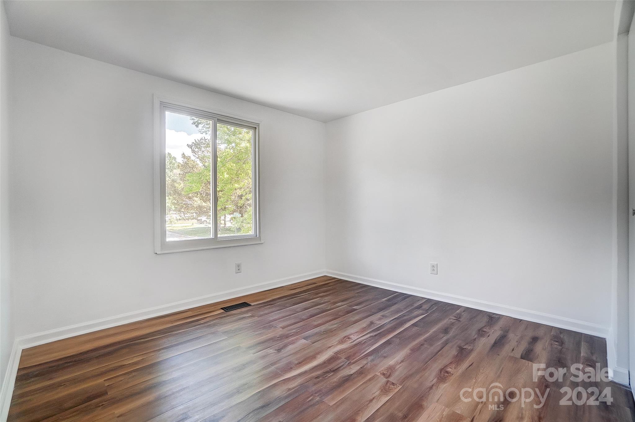 2236 Rice Planters Road Charlotte, NC 28273 - Photo 22 of 43 wooden floor in an empty room with a window