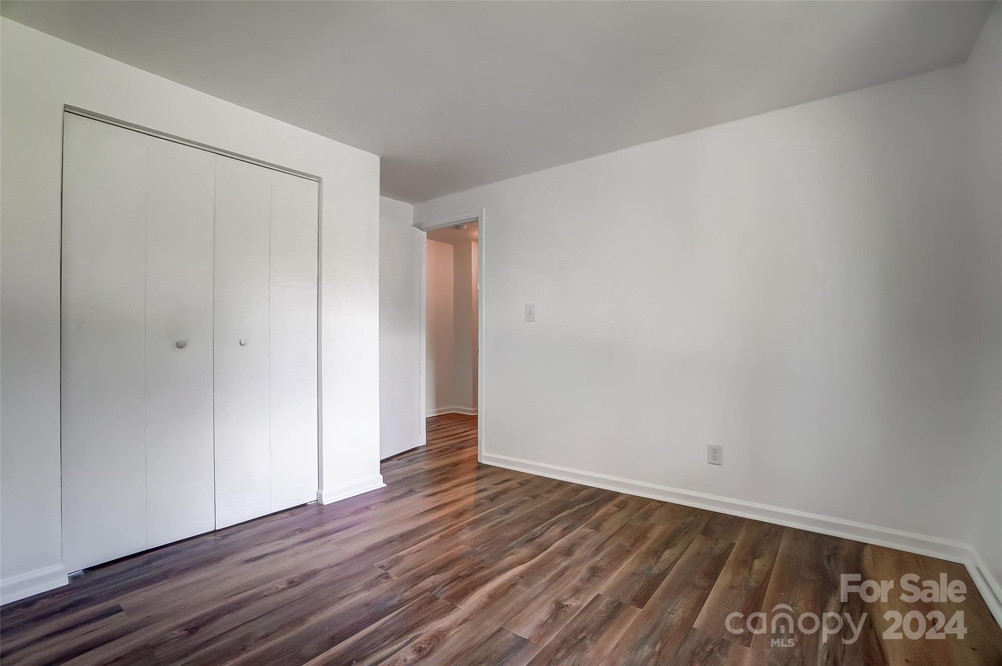 2236 Rice Planters Road Charlotte, NC 28273 - Photo 23 of 43 a view of an empty room with wooden floor