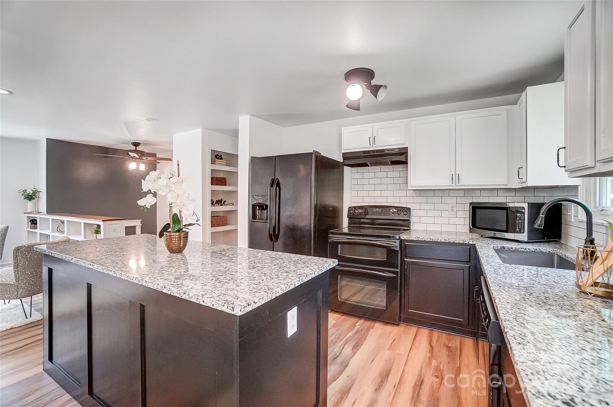 2236 Rice Planters Road Charlotte, NC 28273 - Photo 10 of 43 a kitchen with stainless steel appliances granite countertop a stove refrigerator sink and cabinets