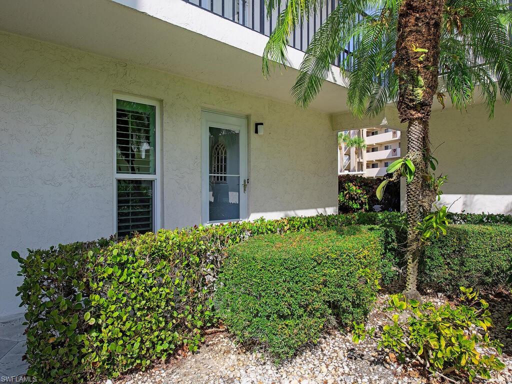 53 High Point Circle West, Unit 101 Naples, FL 34103 - Photo 13 of 18 a plant that is in front of a house