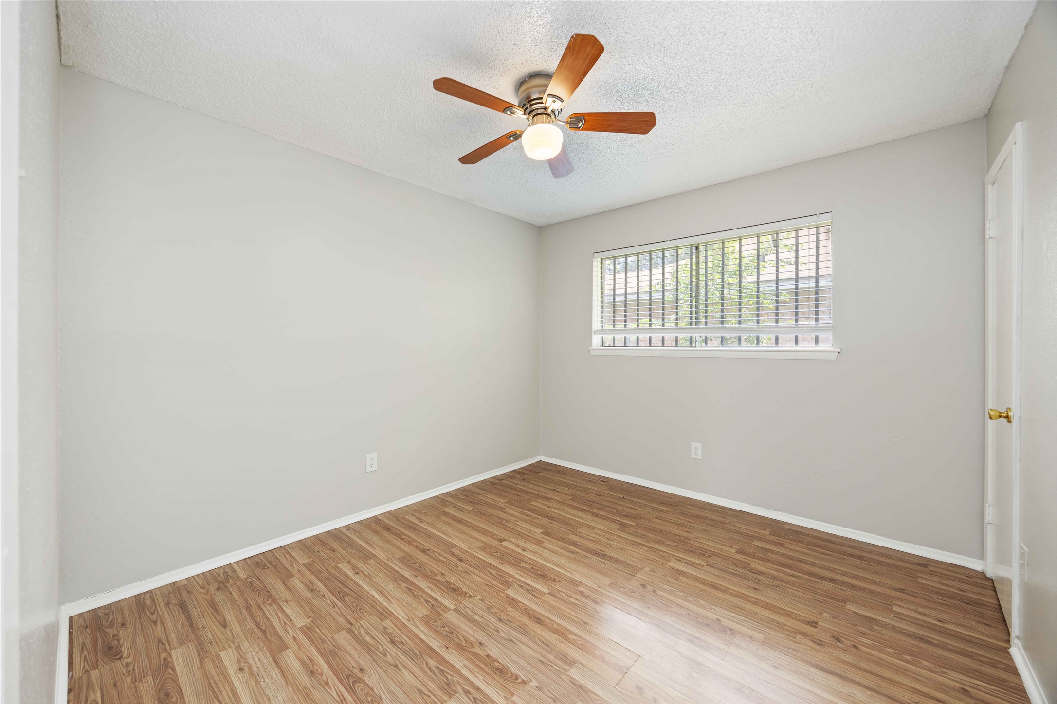 11750 Murr Way Houston, TX 77048 - Photo 17 of 23 an empty room with wooden floor and ceiling fan