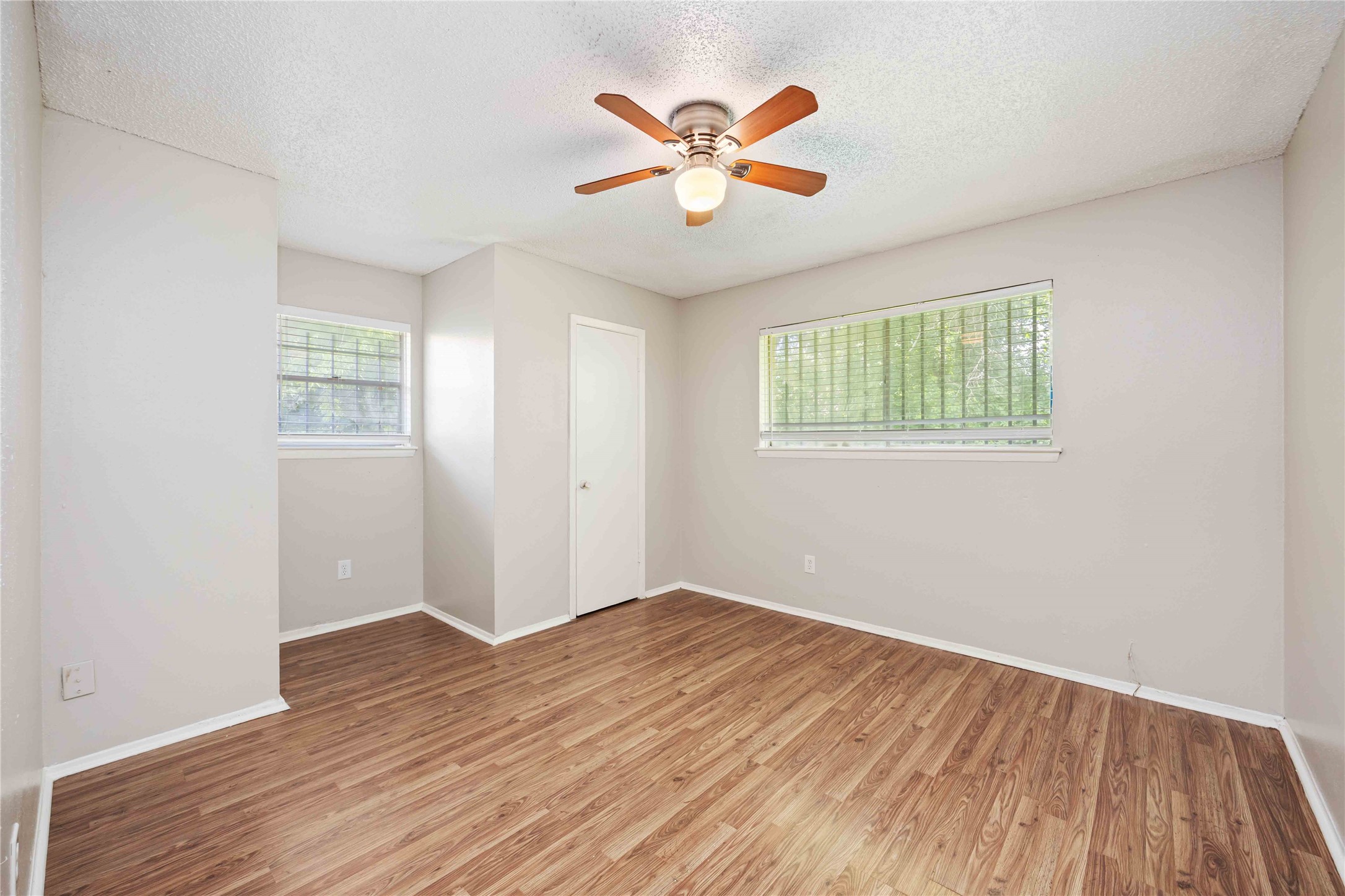 11750 Murr Way Houston, TX 77048 - Photo 19 of 23 an empty room with wooden floor and windows