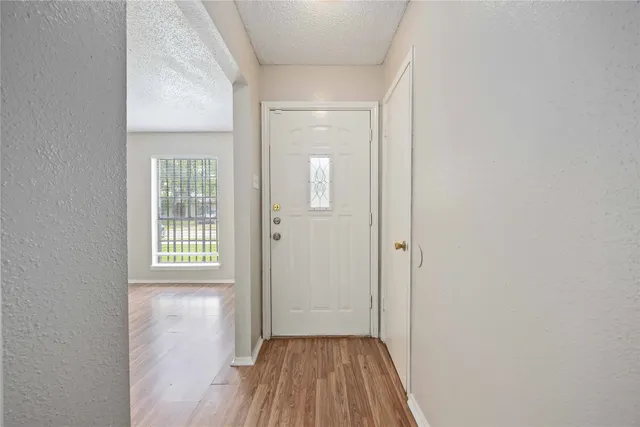 a view of a room with wooden floor and a gate