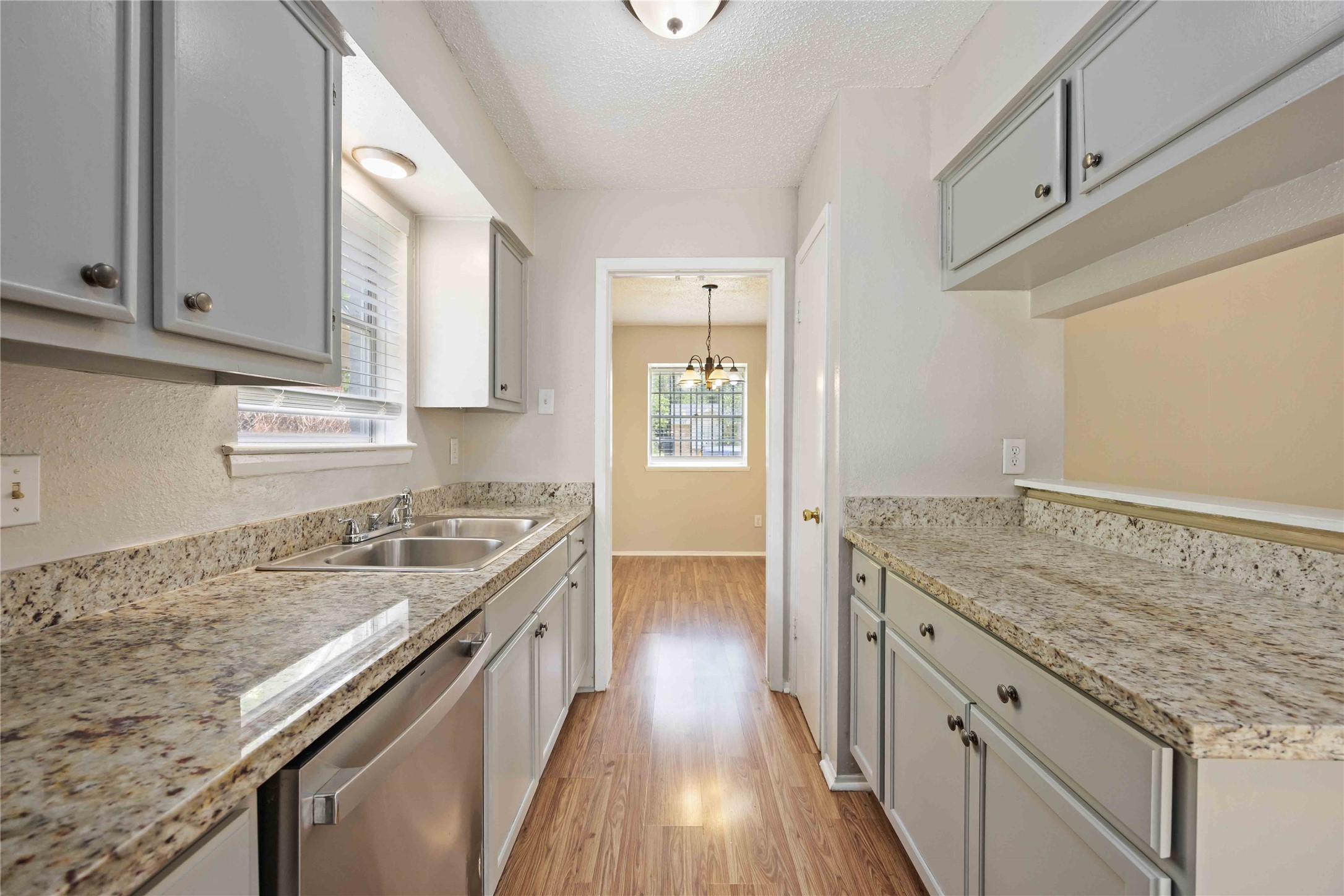 11750 Murr Way Houston, TX 77048 - Photo 9 of 23 a kitchen with granite countertop a sink stove and cabinets