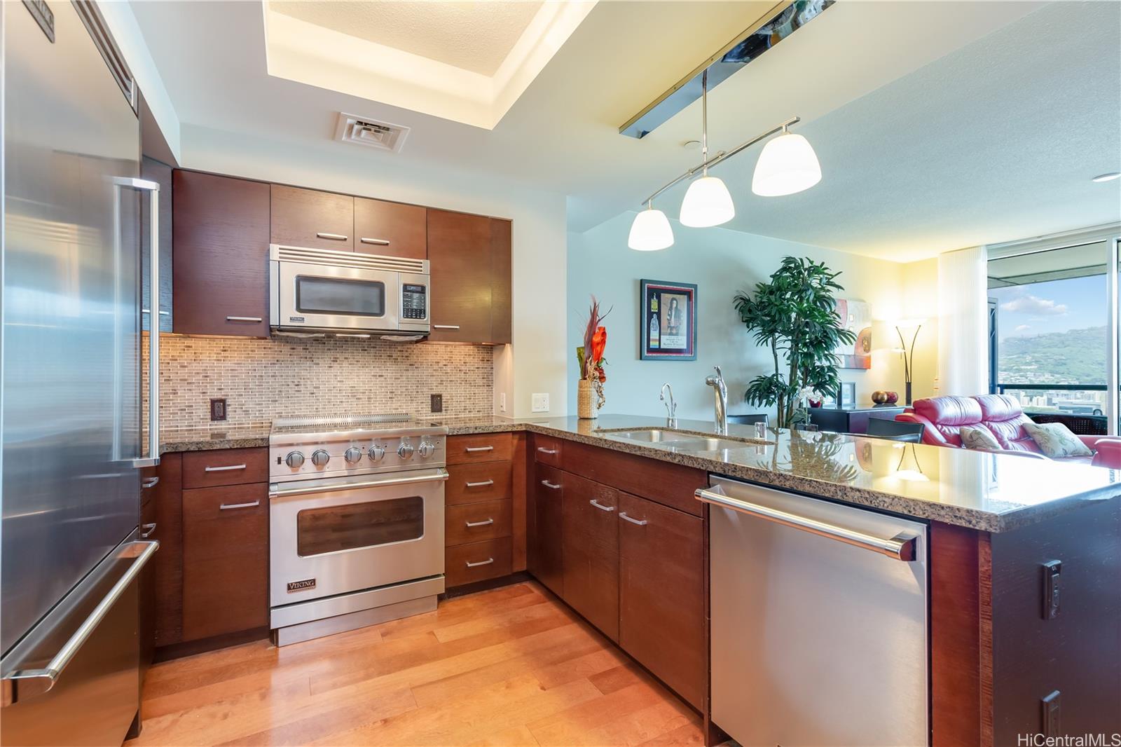 a kitchen with stainless steel appliances a sink stove and refrigerator