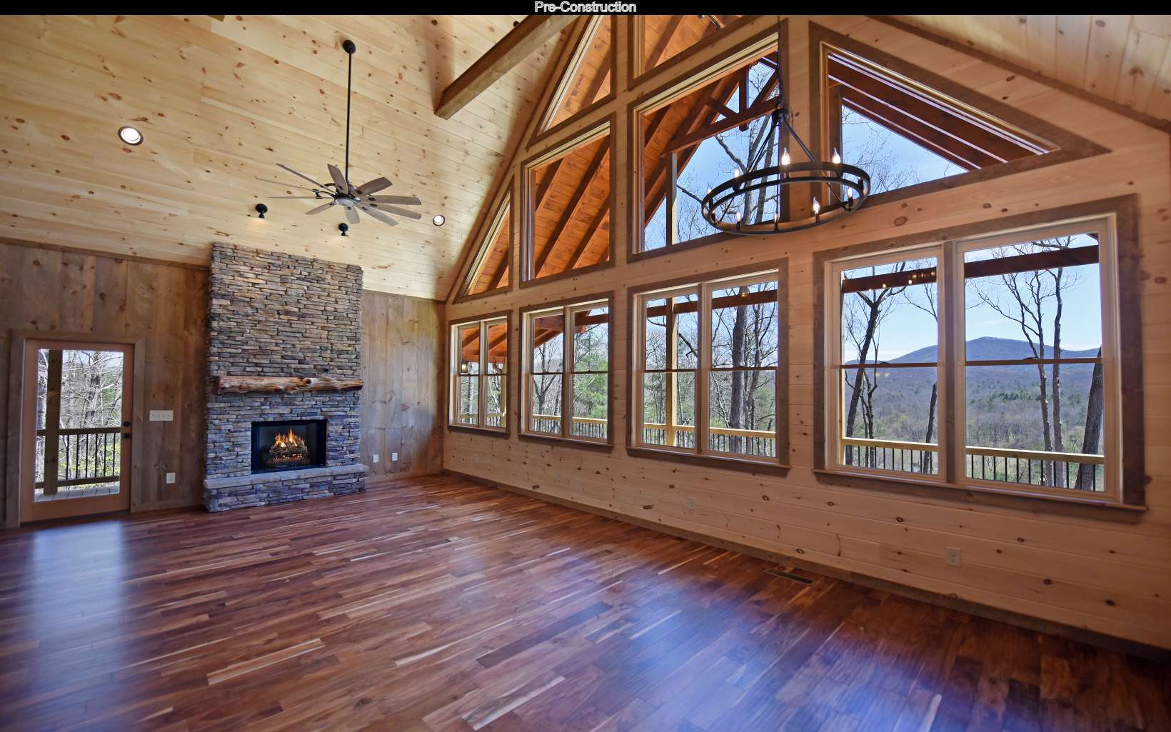 Lot11 Lot11 Native Trail Blue Ridge, GA 30513 - Photo 9 of 44 an empty room with wooden floor fireplace and windows