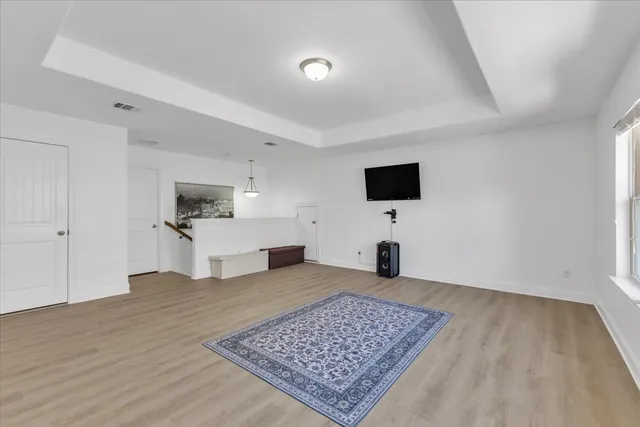 a living room with a flat screen tv and a rug