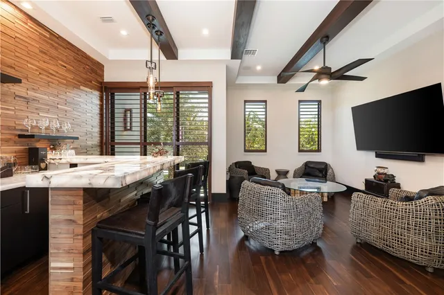 a view of a livingroom with wooden floor chair and front door