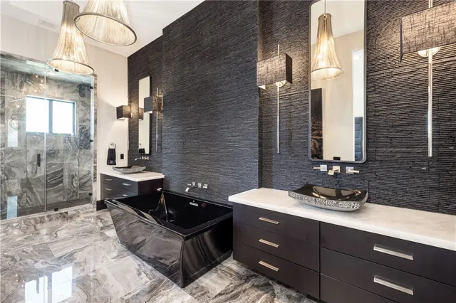 a bedroom with a large bed and a chandelier