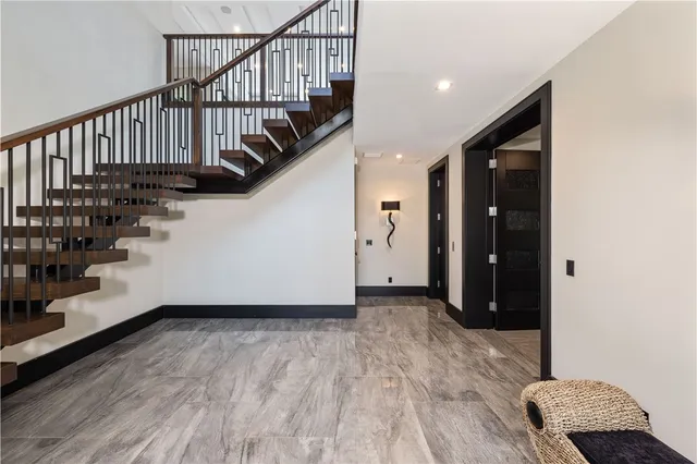 a bathroom with a granite countertop sink a toilet and shower