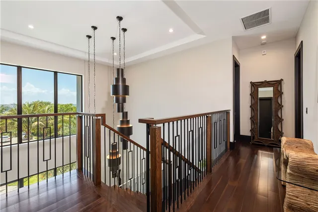 a large bedroom with a bed and flat tv screen