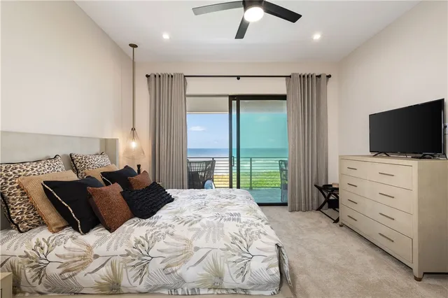 a bathroom with a toilet mirror and vanity