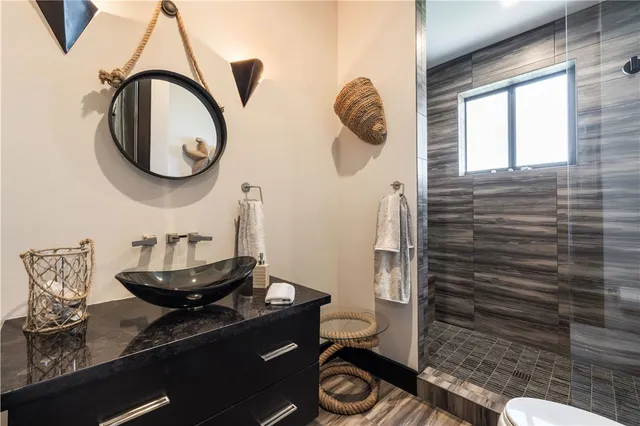 a bathroom with a toilet and a mirror