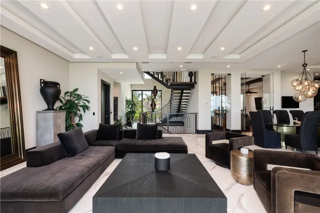 a living room with furniture wooden floor and a large window