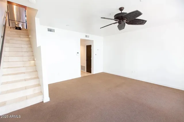 a view of a room with a ceiling fan