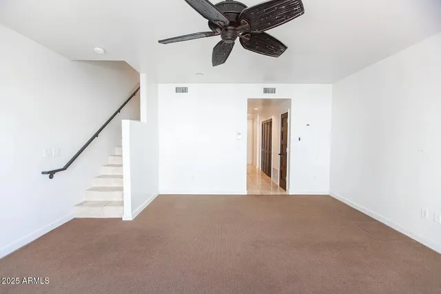a view of a hallway with a ceiling fan