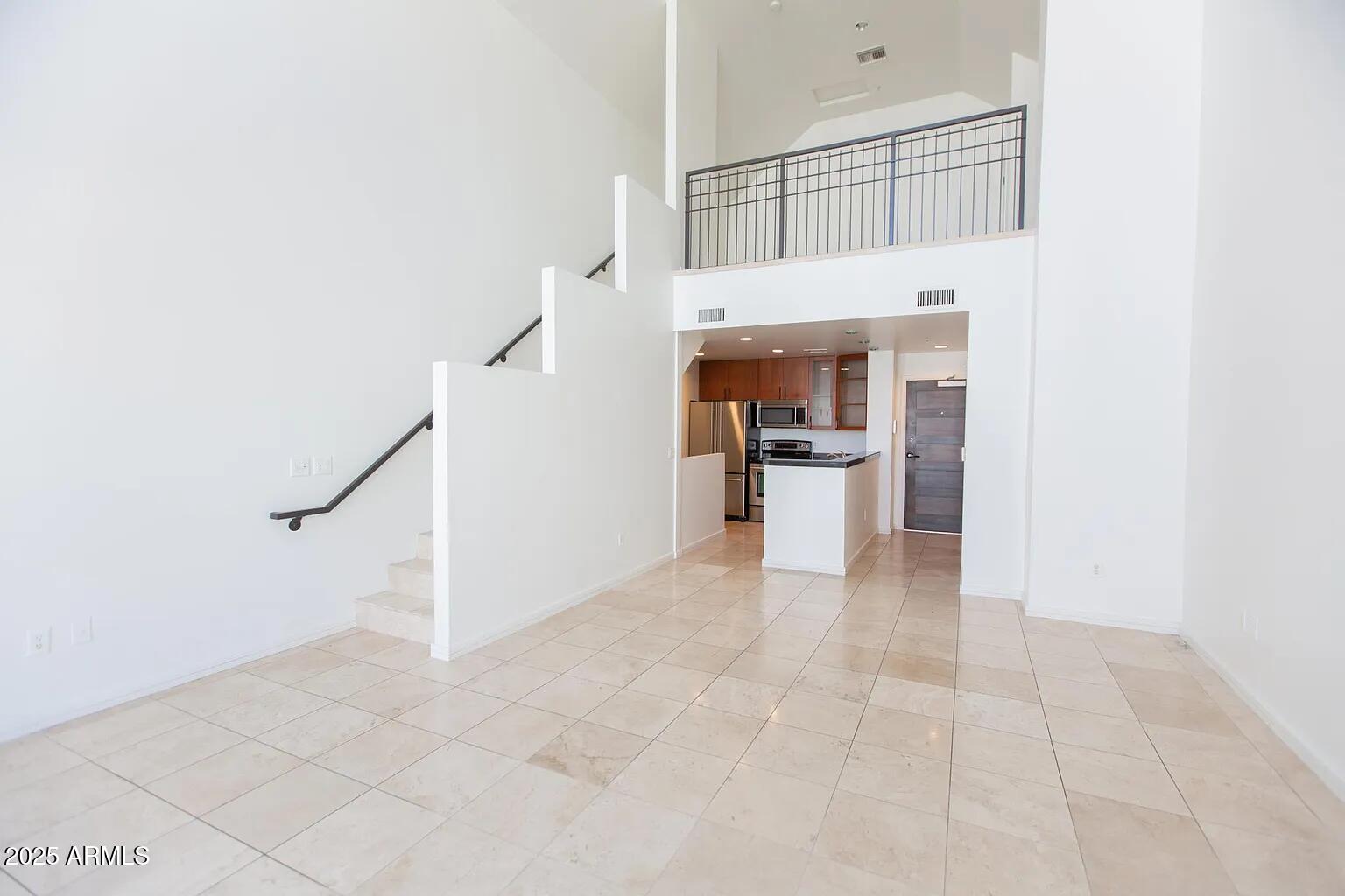 215 East McKinley Street, Unit 408 Phoenix, AZ 85004 - Photo 9 of 19 a view of a kitchen with furniture and an empty room