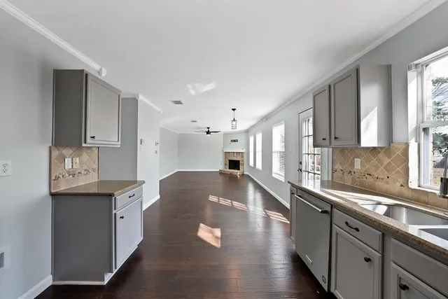 a large kitchen with stainless steel appliances granite countertop a sink and a stove