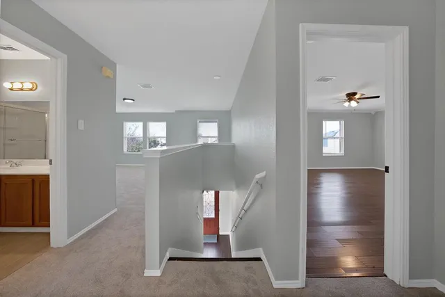 a view of an entryway with wooden floor and cabinet