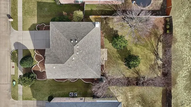 an aerial view of a house with a yard