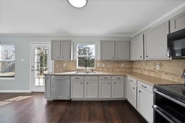 a kitchen with sink cabinets and wooden floor