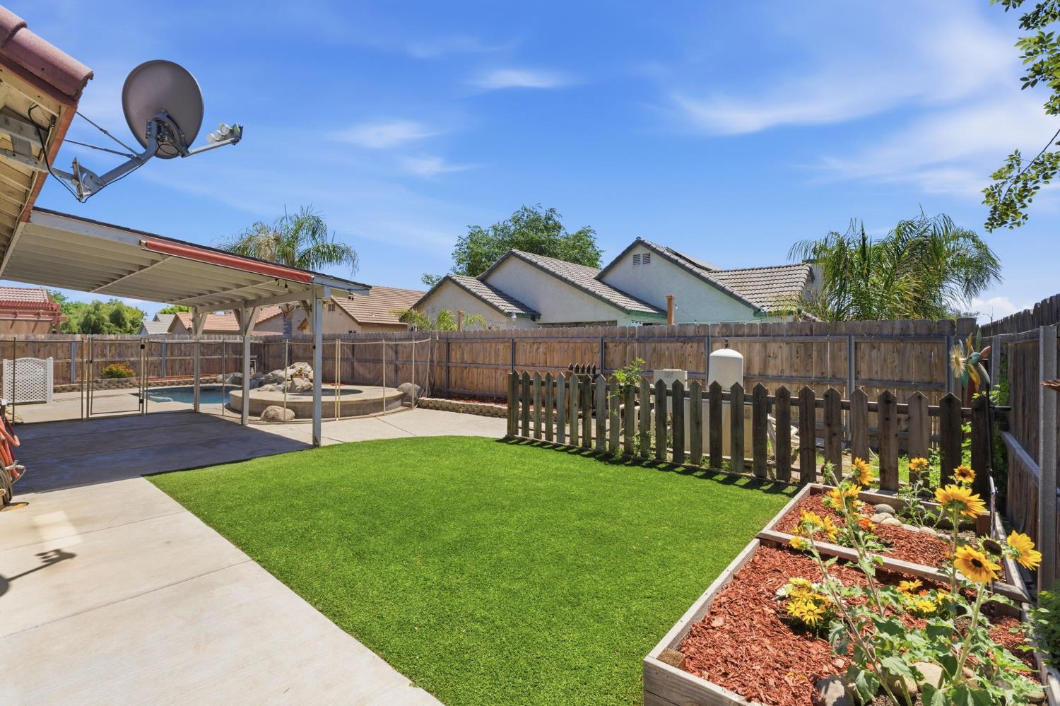 1757 Homestead Way Lemoore, CA 93245 - Photo 30 of 35 a view of a yard with table and chairs a fire pit