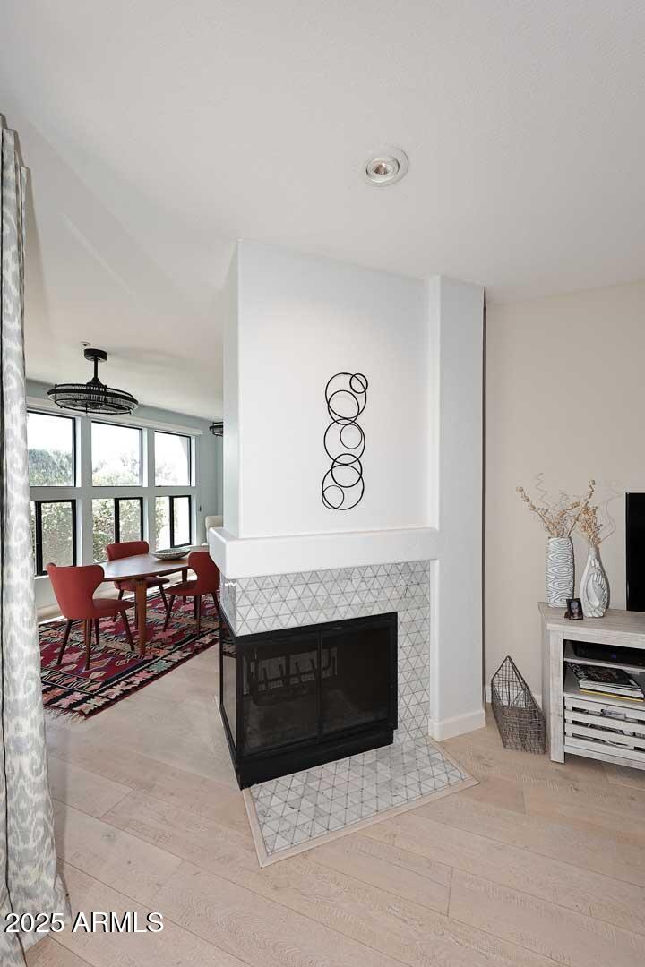 7700 East Gainey Ranch Road, Unit 128 Scottsdale, AZ 85258 - Photo 12 of 60 a spacious bedroom with a bed and a fireplace