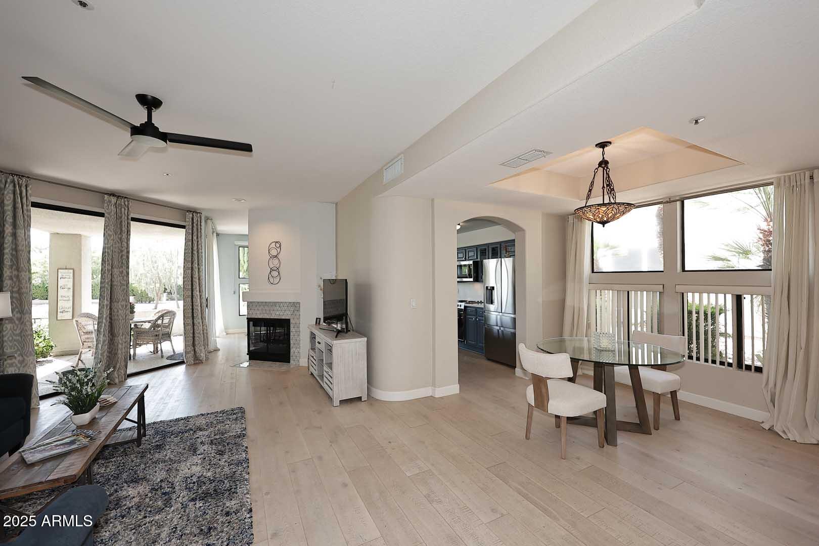 7700 East Gainey Ranch Road, Unit 128 Scottsdale, AZ 85258 - Photo 15 of 60 a living room with furniture and a fireplace