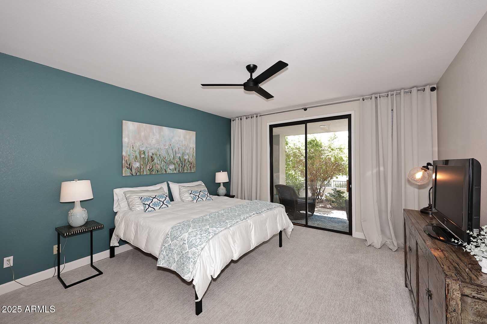 7700 East Gainey Ranch Road, Unit 128 Scottsdale, AZ 85258 - Photo 19 of 60 a bedroom with a bed tv and a window