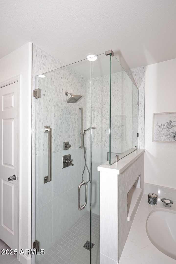 7700 East Gainey Ranch Road, Unit 128 Scottsdale, AZ 85258 - Photo 24 of 60 a bathroom with a shower and a tub
