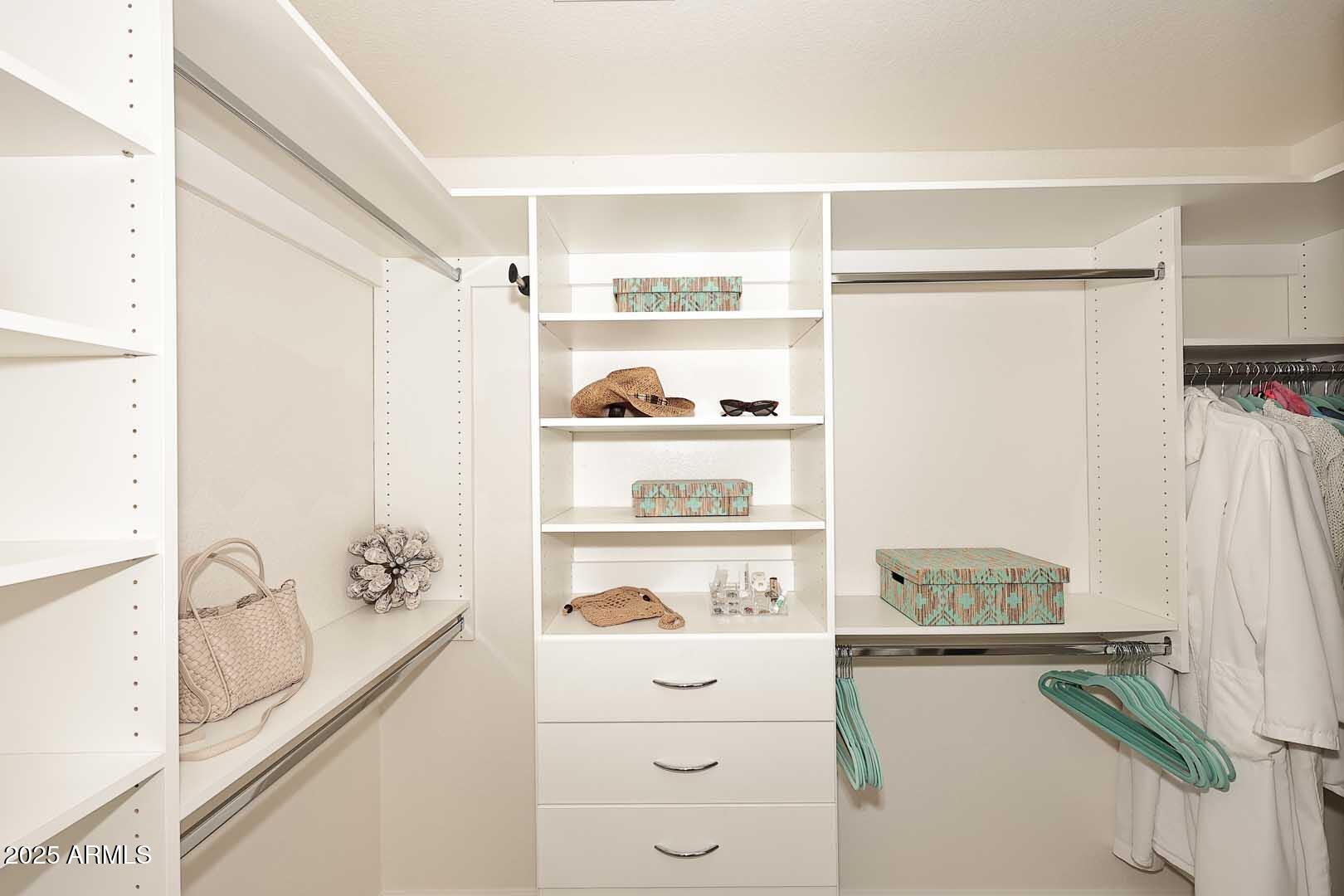7700 East Gainey Ranch Road, Unit 128 Scottsdale, AZ 85258 - Photo 25 of 60 a kitchen with a refrigerator and white cabinets