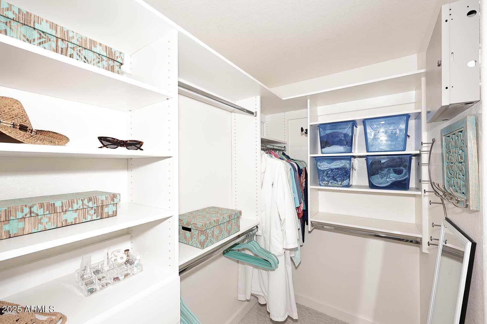 7700 East Gainey Ranch Road, Unit 128 Scottsdale, AZ 85258 - Photo 26 of 60 a view of walk in closet with clothes and shoes
