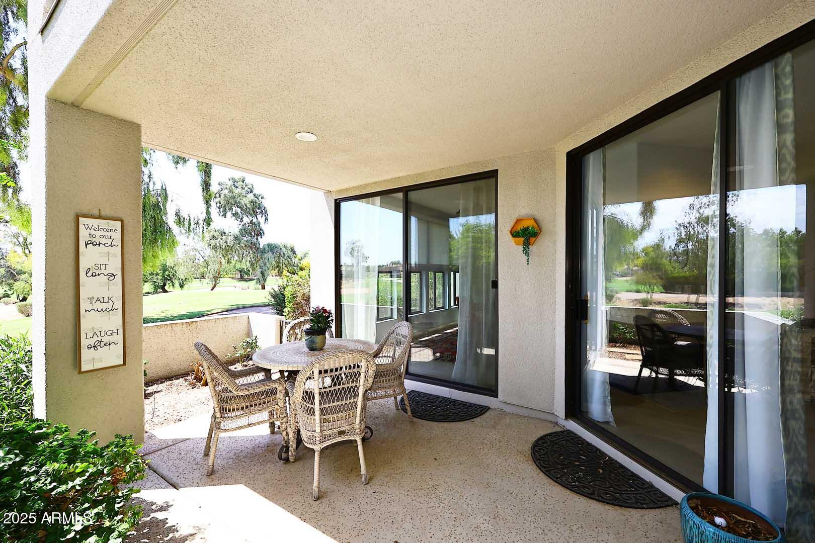7700 East Gainey Ranch Road, Unit 128 Scottsdale, AZ 85258 - Photo 28 of 60 a dining room with furniture and a floor to ceiling window