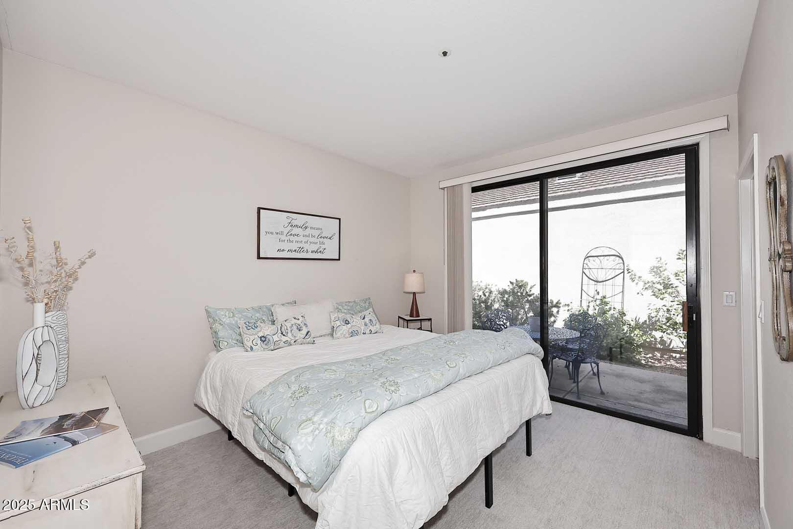 7700 East Gainey Ranch Road, Unit 128 Scottsdale, AZ 85258 - Photo 29 of 60 a bedroom with a large bed and a large window